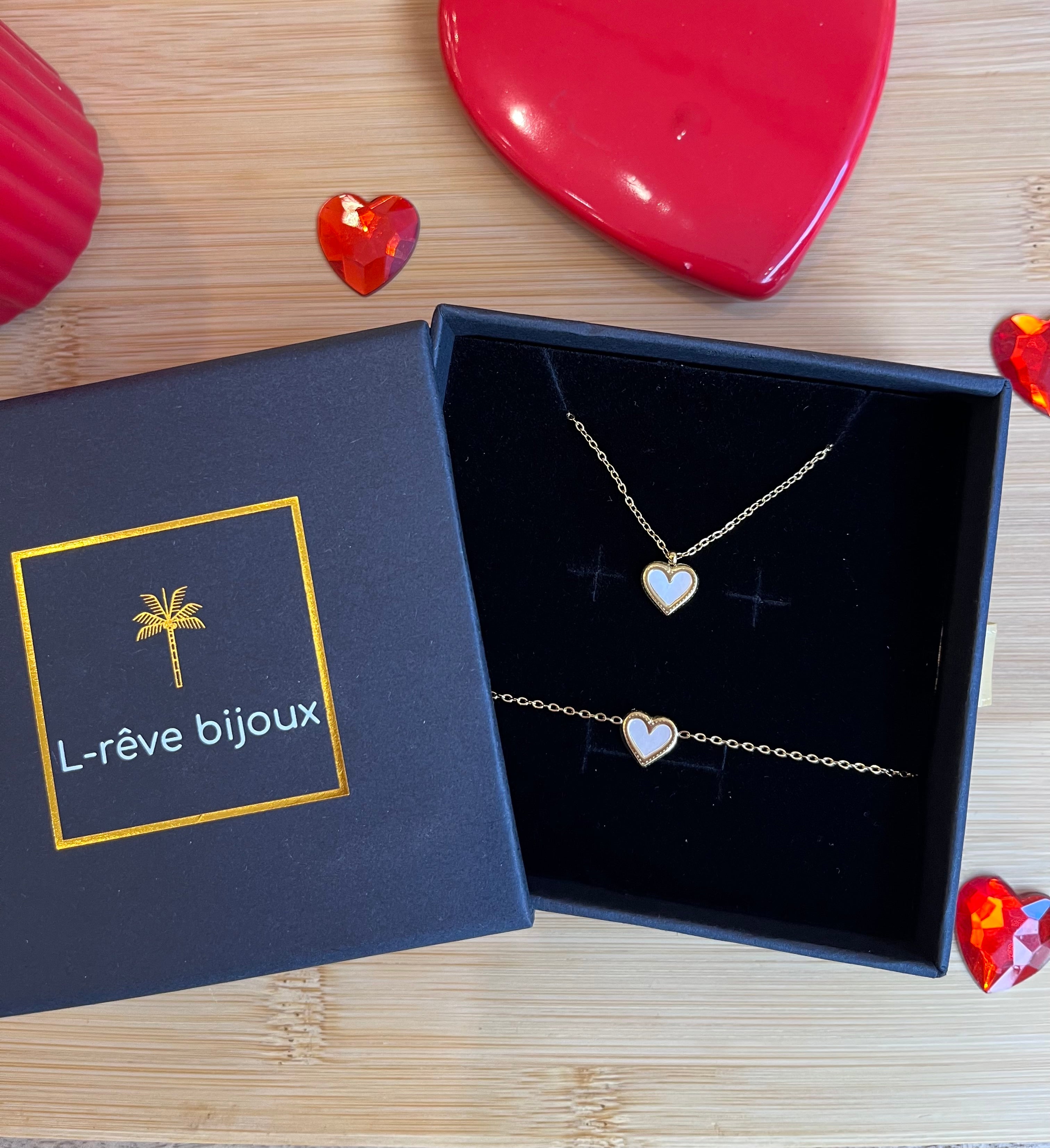 Coffret cadeau comprenant un collier et un bracelet ayant un cœur doré en guise de pendentif 