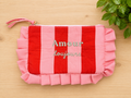 pochette a zip rayée rouge et rose avec message