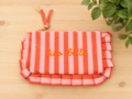 pochette a zip rayée rose et orange avec message